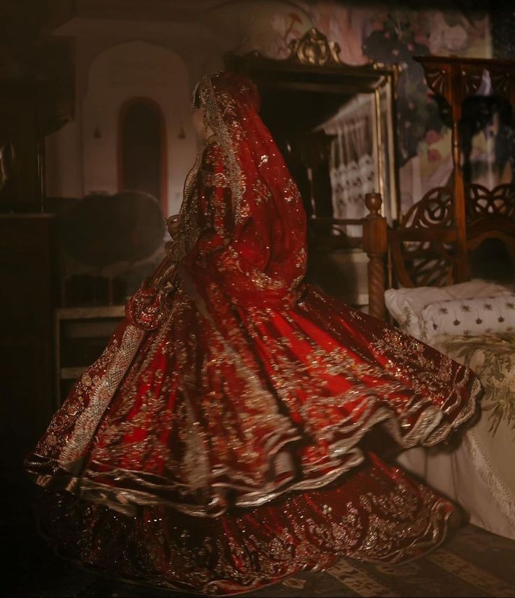 premium bride look red lehenga with intricate gold embroidery, representing opulent and timeless wedding couture.